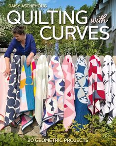 the cover of quilting with curves book shows a woman leaning on a fence and looking at several colorful towels