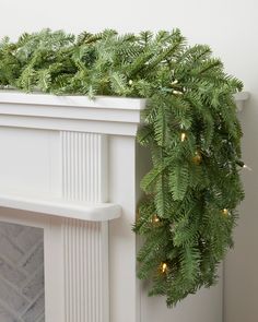 a christmas garland is hanging on the fireplace mantel