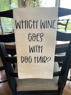 a sign that says which wine goes with dog hair? on the back of a chair