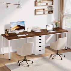 a desk with two chairs and a computer on it