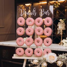 donuts are arranged in the shape of a pyramid on a table at a wedding