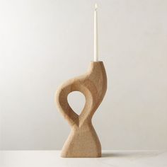 a wooden candle holder with a white candle