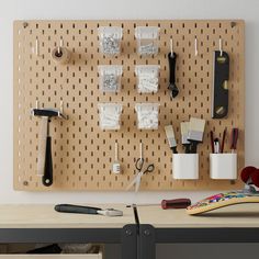 a peg board with scissors and other crafting supplies on it