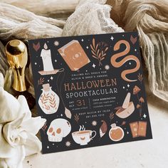 a halloween spooktacular party is set up on a table with white flowers