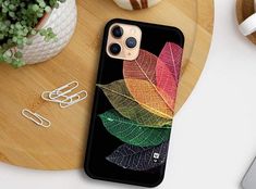 an iphone case with colorful leaves on it