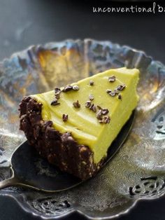 a piece of cake sitting on top of a silver plate with a spoon in it