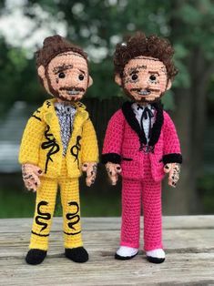 two crocheted dolls are standing next to each other, one is wearing a suit and the other has a tie