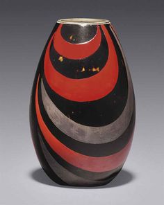 a black and red vase sitting on top of a table