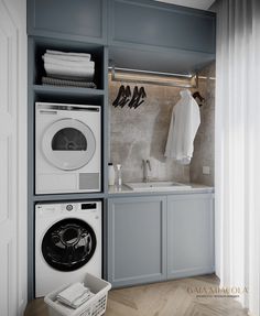 a washer and dryer in a laundry room with clothes hanging on the rack