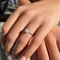 a woman's hand with a diamond ring on it