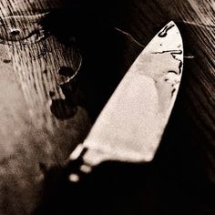 a knife laying on top of a wooden table