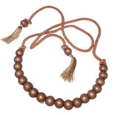 a brown beaded bracelet with tassels