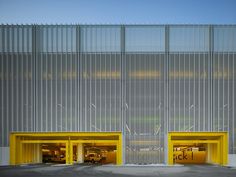 an empty parking garage with two yellow doors