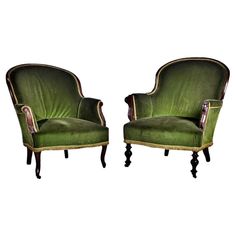 a pair of green chairs sitting next to each other