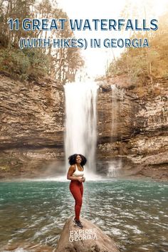 a woman standing on top of a rock in front of a waterfall