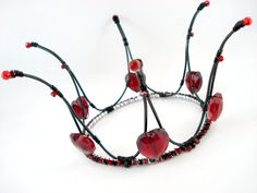 a red and black tiara on a white background