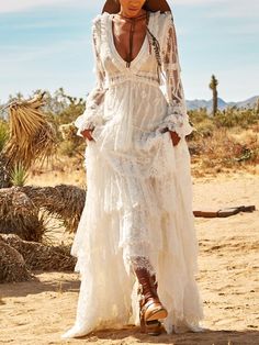 a woman in a white dress and cowboy boots