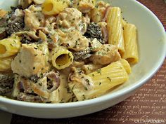 a white bowl filled with pasta and meat