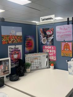 an office cubicle with posters on the wall