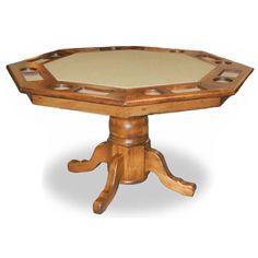 a wooden table with a white top and an intricately carved design on the base