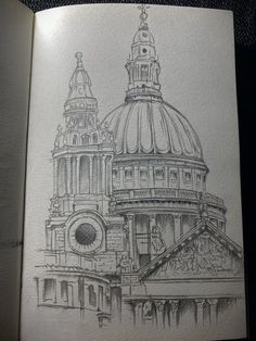 an open book with a drawing of a building