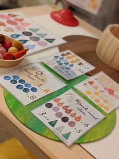 a bowl of candy sitting on top of a table next to cards and bowls of candies