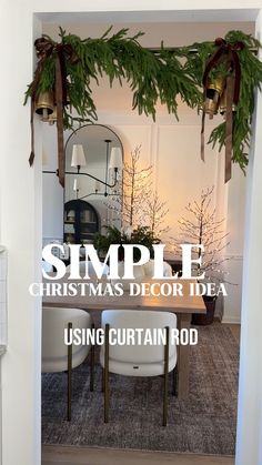 simple christmas decor idea using curtain rod for the dining room table and chairs with greenery on top