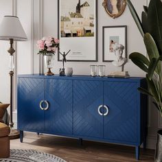 a blue cabinet in a living room with pictures on the wall