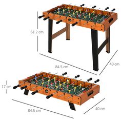 two tables with foosballs on them and measurements for each table in the same room