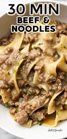 a white bowl filled with beef and noodles