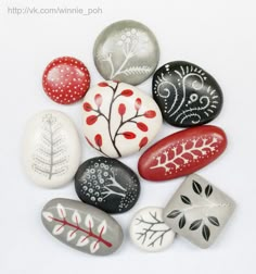 a group of painted rocks sitting on top of a white table next to each other