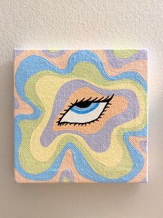 an eye painted on canvas mounted to the wall