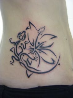 a woman's stomach with a tattoo design on the bottom part of her stomach