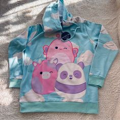 Squishmallows X Dolls Kill Hoodie / Dress Size Medium (Oversized Fit) All Over Cloud Print Baby Blue With Pink & White Swish Mallows 24” Underarm To Underarm 19” Shoulder To Shoulder 30” Shoulder To Hem New With Tags In Original Packaging New Squishmallows, Butterfly Crewneck, Love Smiley, Skull Sweater, Cloud Print, Velour Hoodie, Hoodie Vest, Green Hoodie, Sweatpants Set