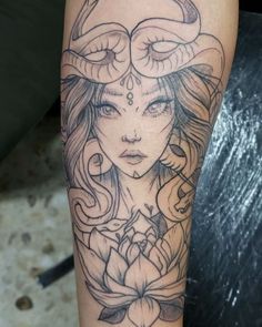 a woman with horns and flowers on her arm