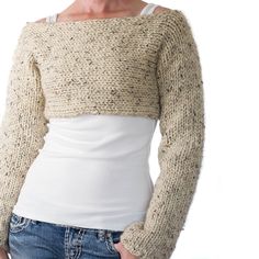 a woman is wearing a sweater and jeans