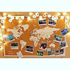 a cork board with pictures and lights around it