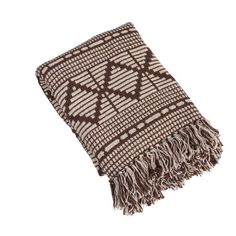 a brown and white throw with fringes on it's ends, sitting on a white surface