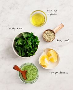 the ingredients to make this green smoothie are shown in small bowls on a white surface