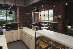 an open kitchen with lots of food on the counter and in front of large windows