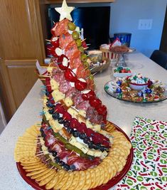 a christmas tree made out of crackers on top of a table with other food items