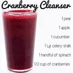 a glass filled with cranberry cleanser sitting on top of a table