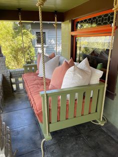 a porch swing bed with pillows on it