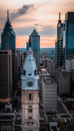 an aerial view of a city with tall buildings and a clock tower in the foreground