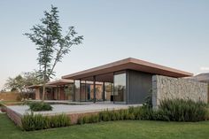 a modern house in the middle of a grassy area