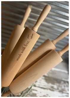 four wooden utensils in a glass jar with the words, mother's day written on them