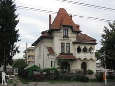 an old white house with a red roof