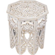 an ornate white wooden table with carvings on the top and sides, isolated against a white background