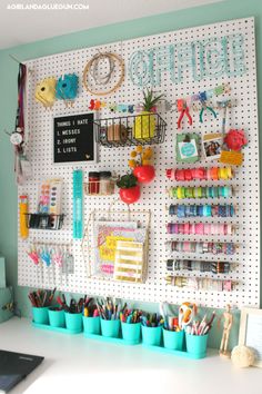 a white pegboard with lots of crafting supplies on it