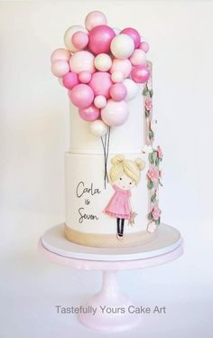 a birthday cake decorated with pink and white balloons